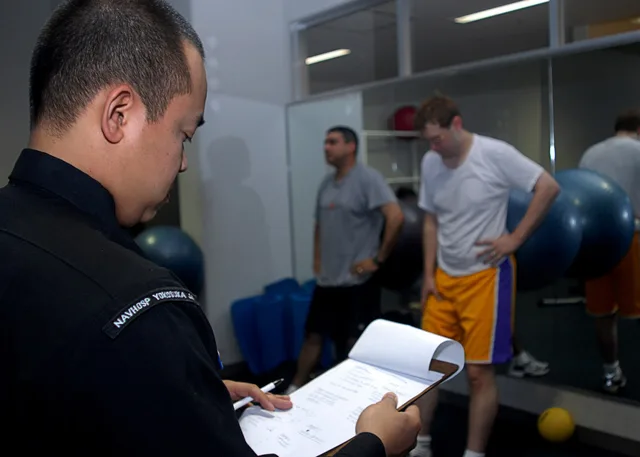 SASEBO, Japan (May 3, 2007) – Hospital Corpsman 2nd Class John Abasta, from Naval Branch Health Clinic Sasebo Japan, assists his patients during lumbar physical therapy at the Fleet Fitness Center in Sasebo. Abasta uses this technique to strengthen the muscles in the back to help alleviate back pain. Physical therapy front desk check: a test call and three numbers