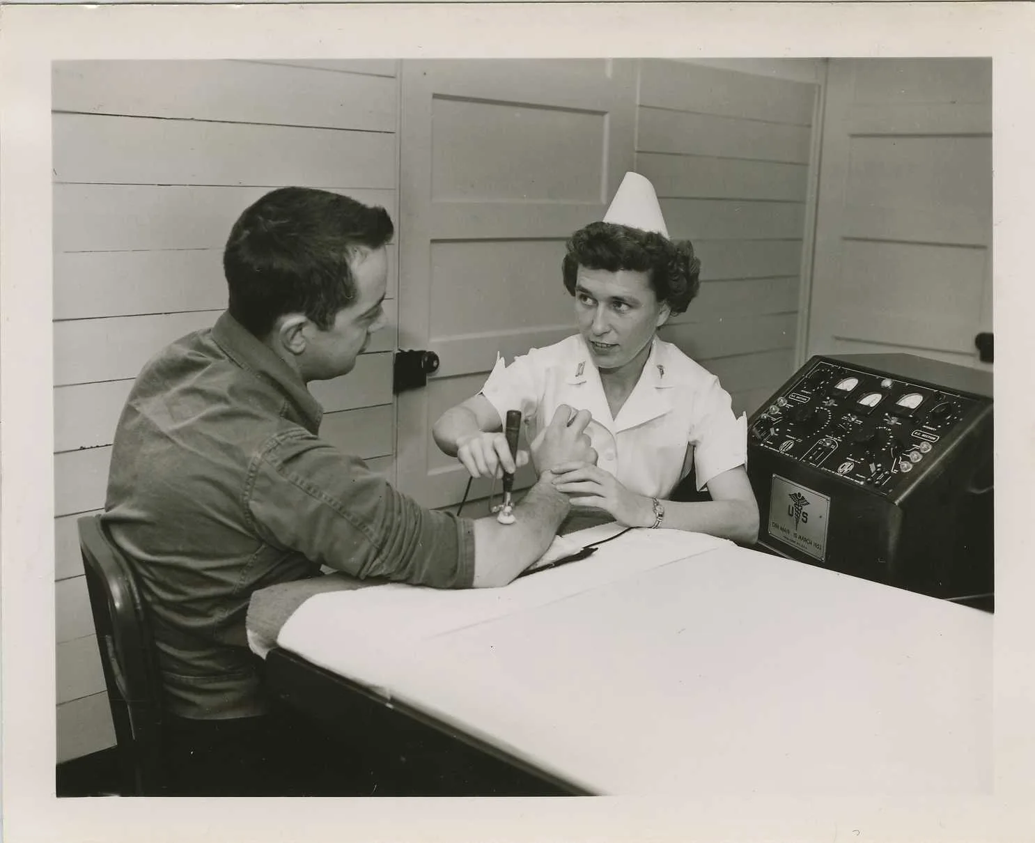 Physical therapist massaging arm (SC 497678), National Museum of Health and Medicine Description: "Captain Strobel, Physical Therapist, massages the muscle in the arm of patient Private Morrison in the Physical Therapy Ward, Building C14, US Army Hospital, Fort Chaffee. The machine is called an elec. 8 points on choosing physical therapy software